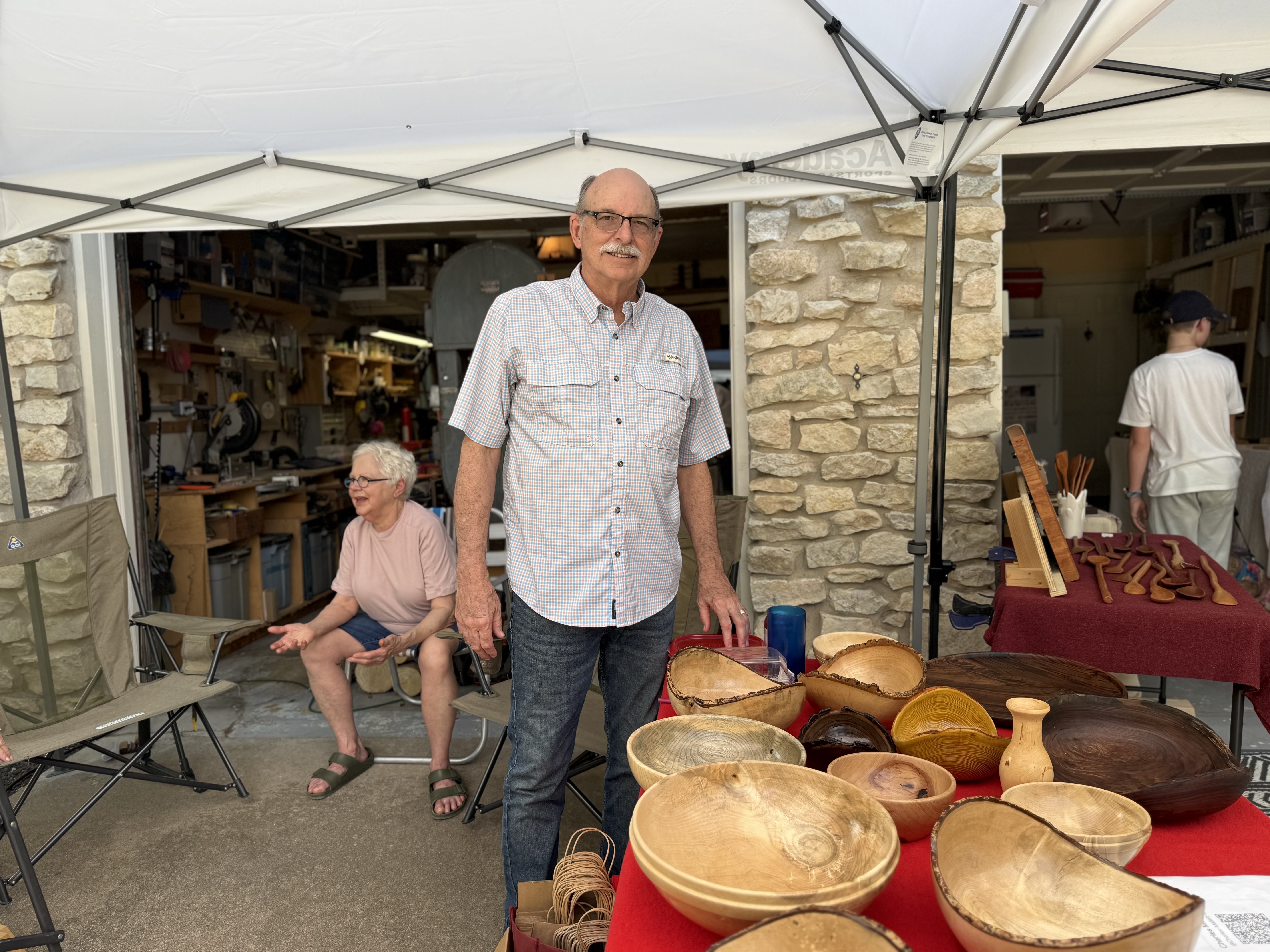 Chuck Mallett at his booth with turned wooden bowls