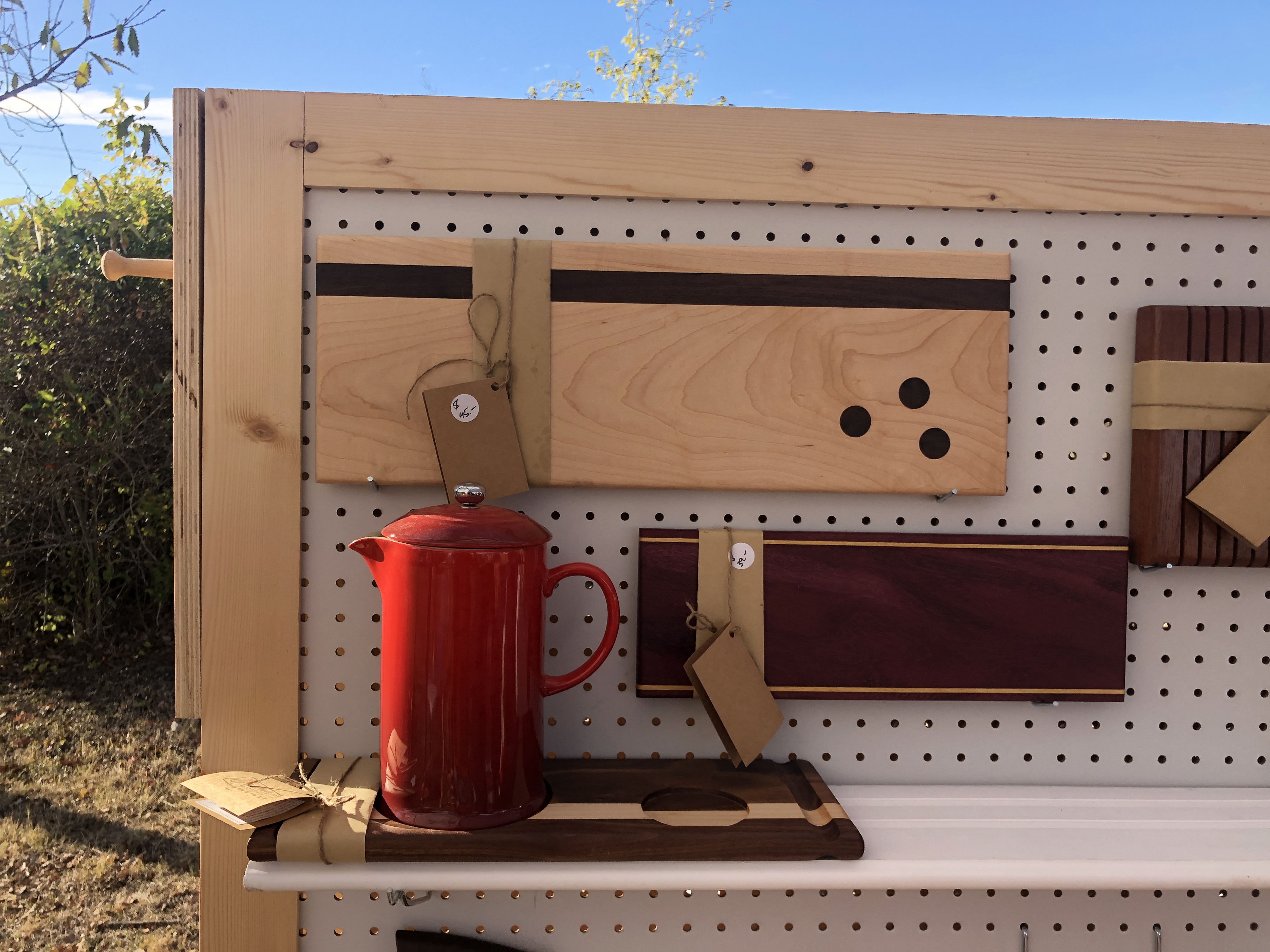 Handcrafted cutting boards on display at a craft show