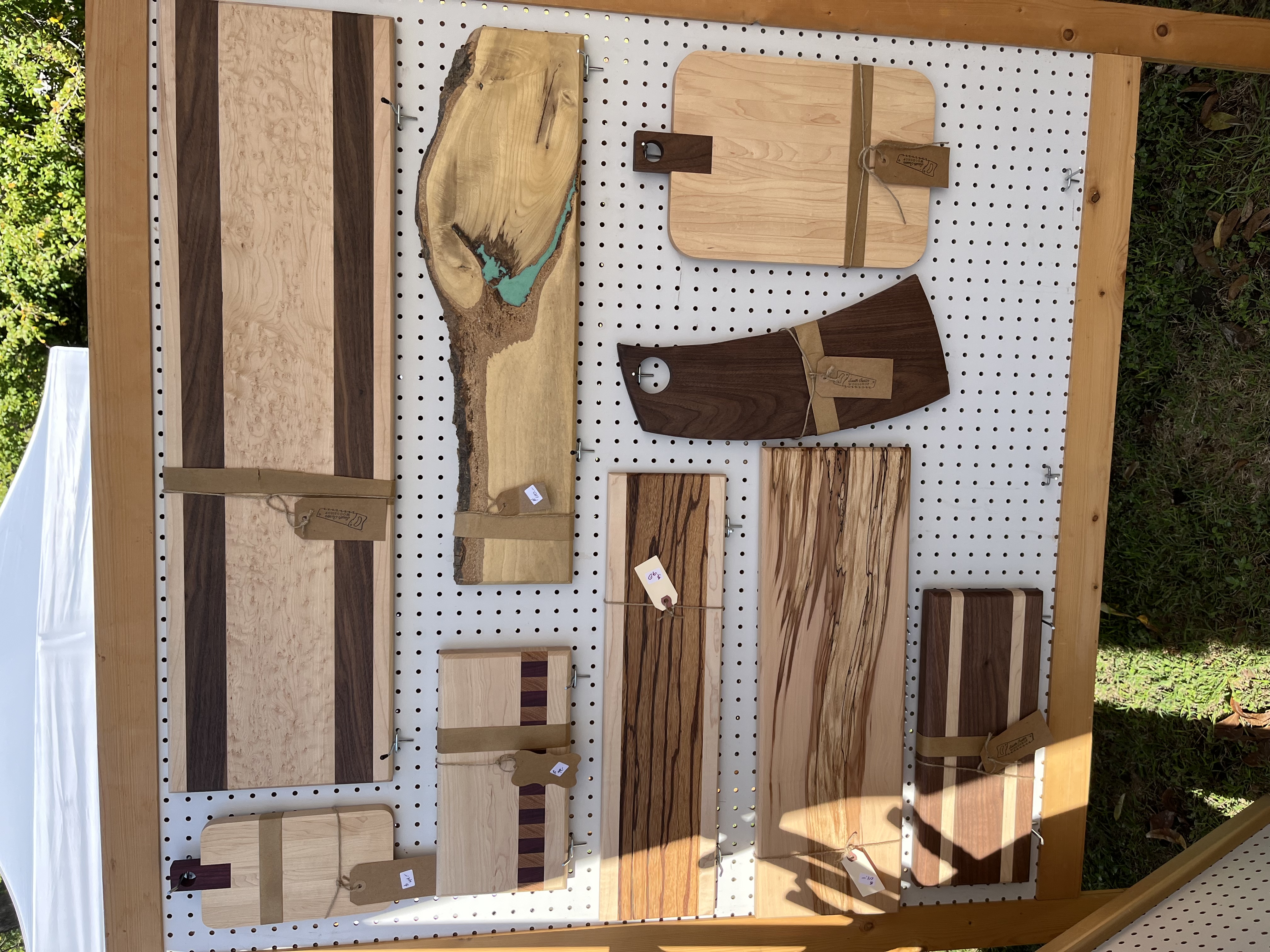 Boards on outdoor pegboard featuring live-edge maple with turquoise inlay