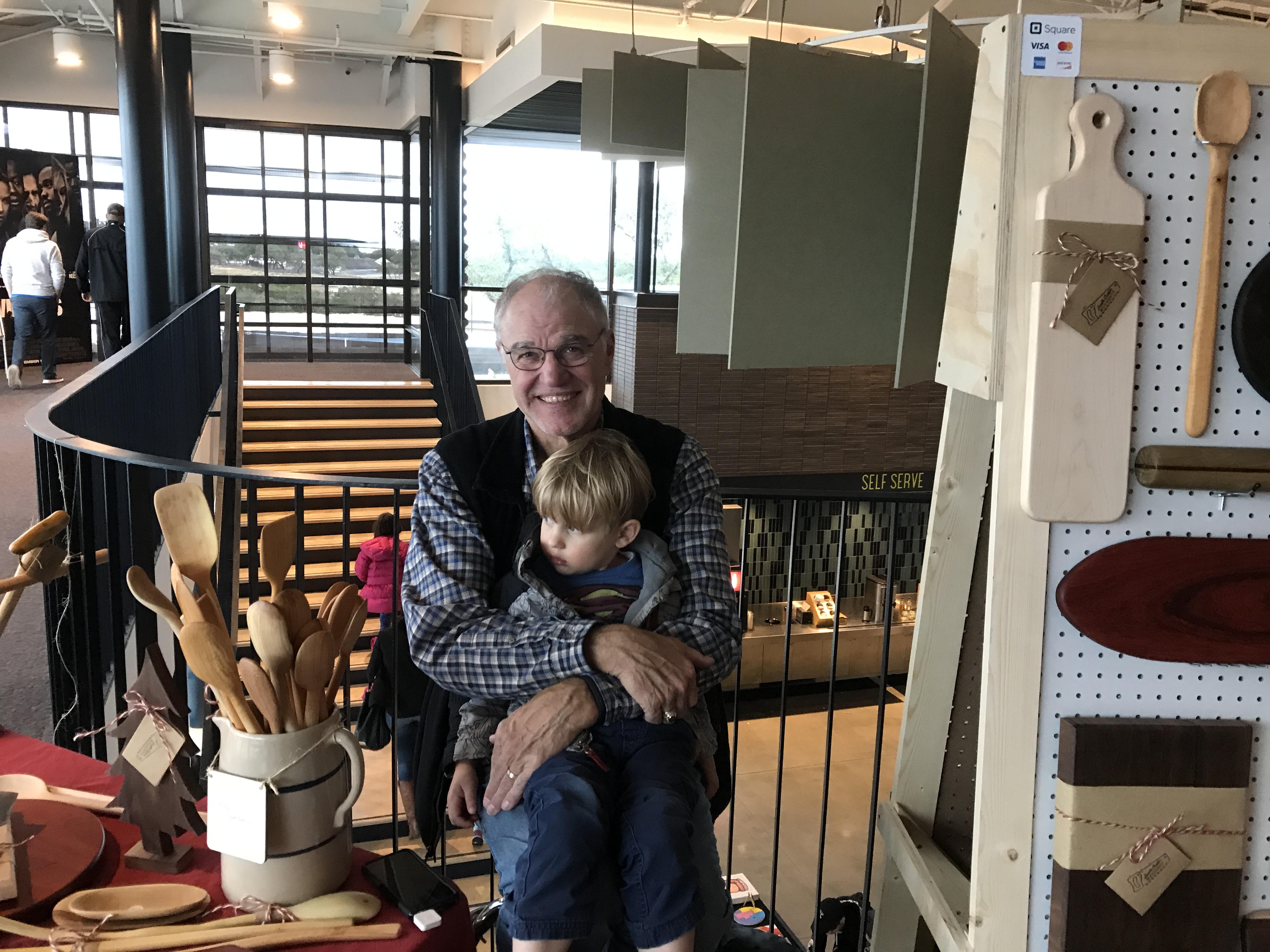Buzz Pruitt with his grandson at a craft show booth