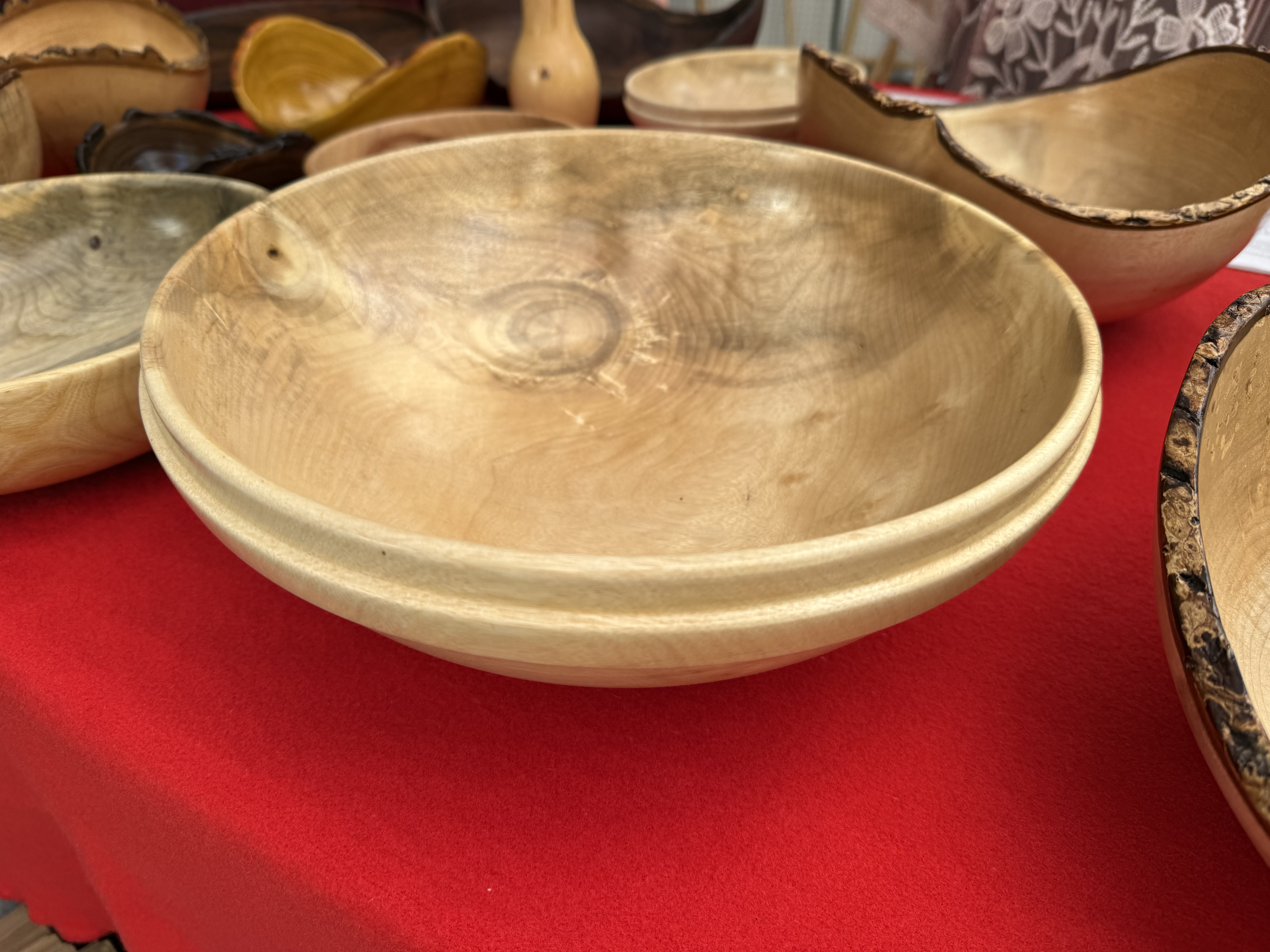 Smooth maple turned bowl on red tablecloth