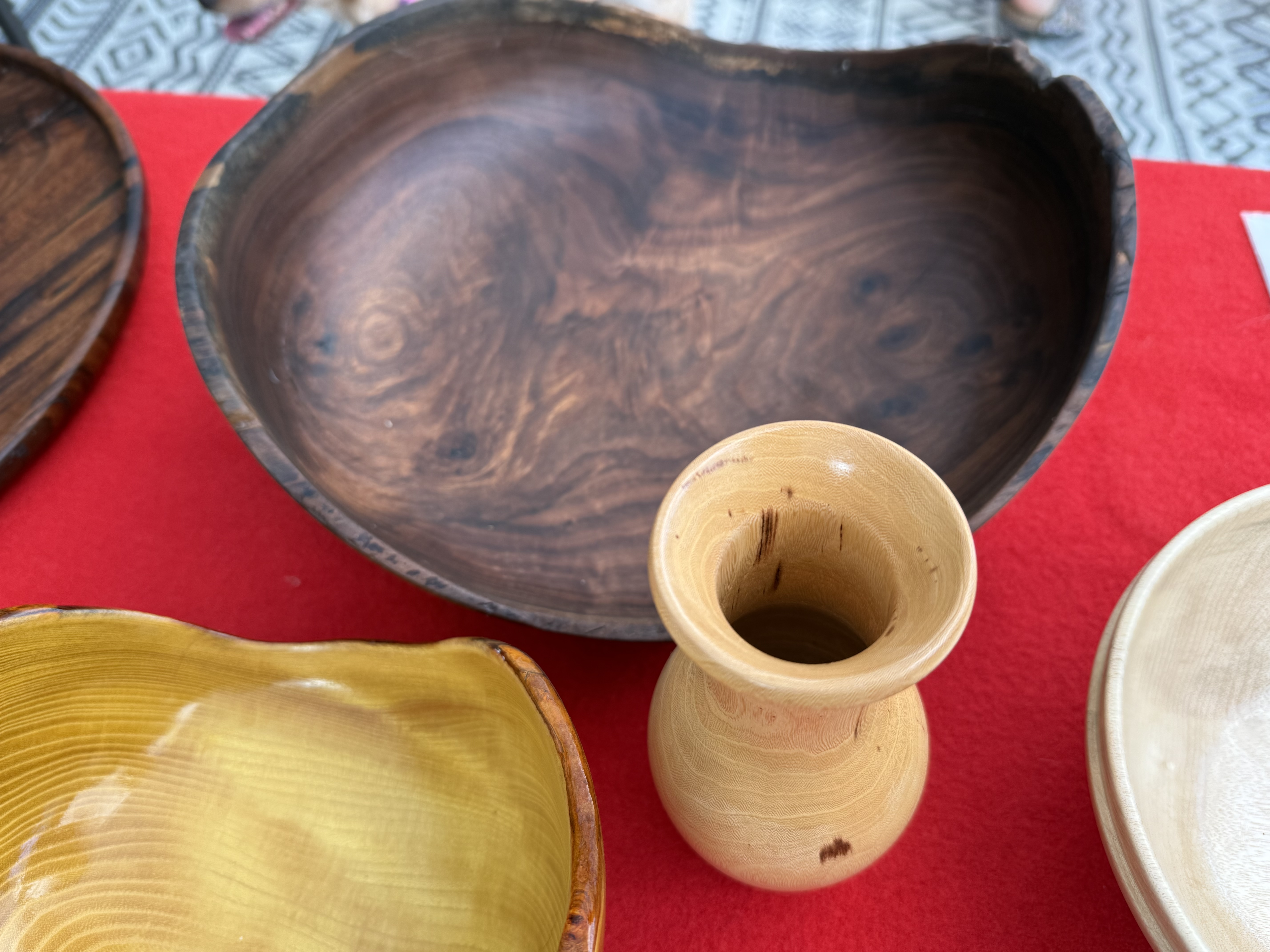 Dark walnut bowl with a small turned vase and yellow-edged vessel